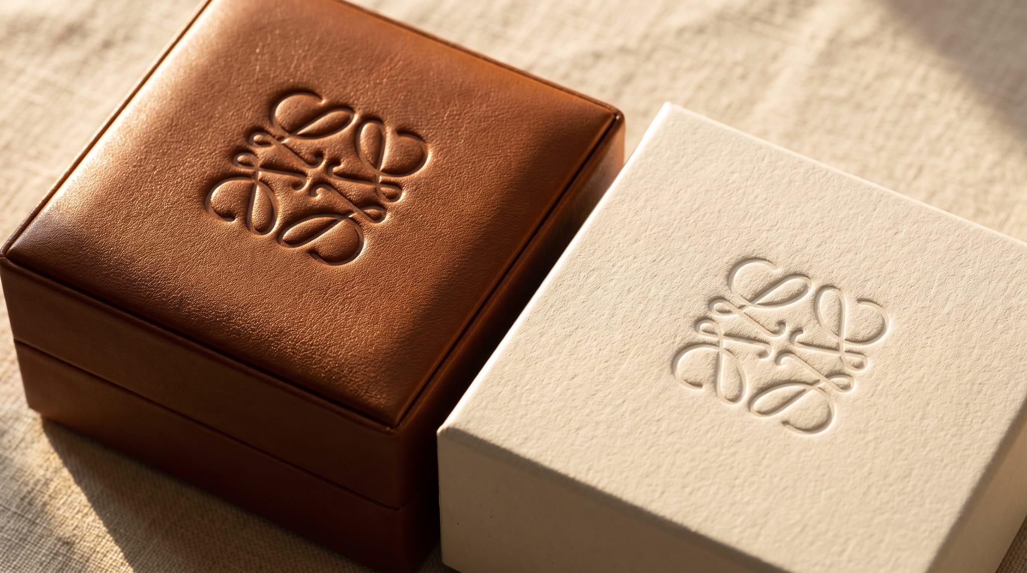 Blind embossing and debossing detail comparison on navy genuine leather and cream leatherette jewelry box lids