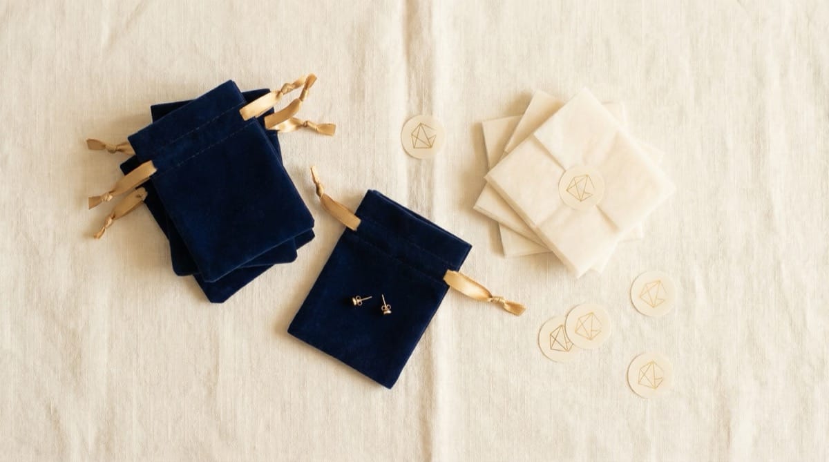 Starter jewelry packaging set for small brands — box, pouch, and shopping bag with cohesive branding
